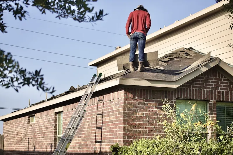 Professional roofer working on a residential roof in Clarinda